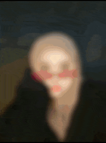 a woman wearing a hijab stands in front of a glowing letter s