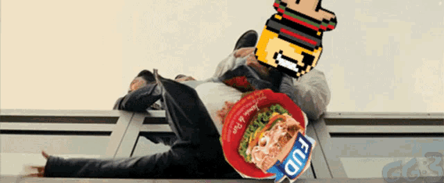 a man is laying on a window sill with a package of fud on his head