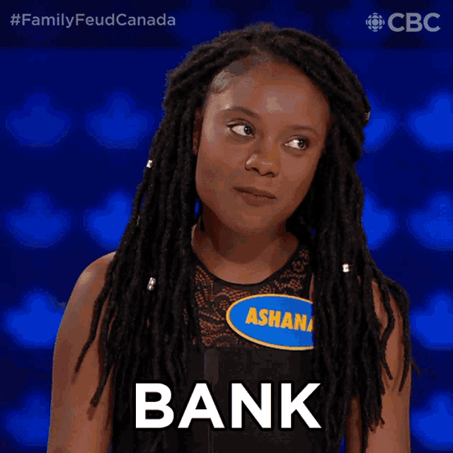 a woman with dreadlocks is wearing a name tag that says asha on it