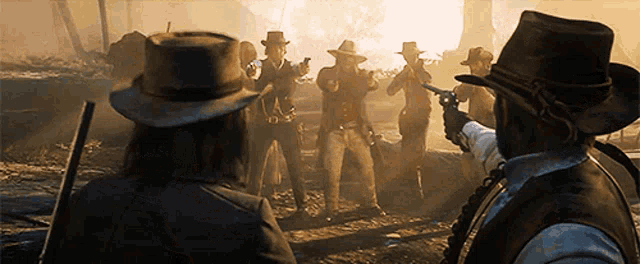 a group of men in cowboy hats are standing in a field with guns .