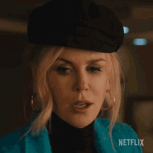a close up of a woman wearing a hat and earrings