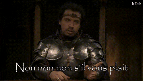 a man in armor is sitting at a table with the words pas d' vanne pas d' reflexion