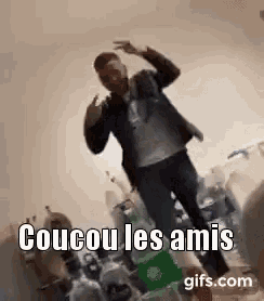 a man is dancing in a room filled with bottles of soda and bottles of water .