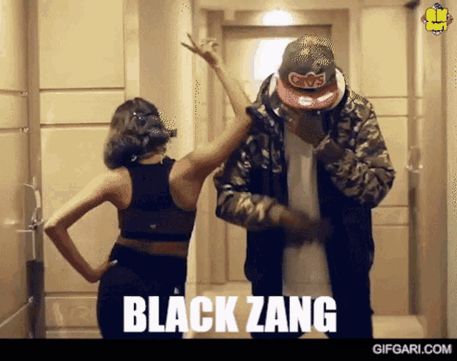 a man and a woman are dancing in a hallway with the words black zang written on the bottom
