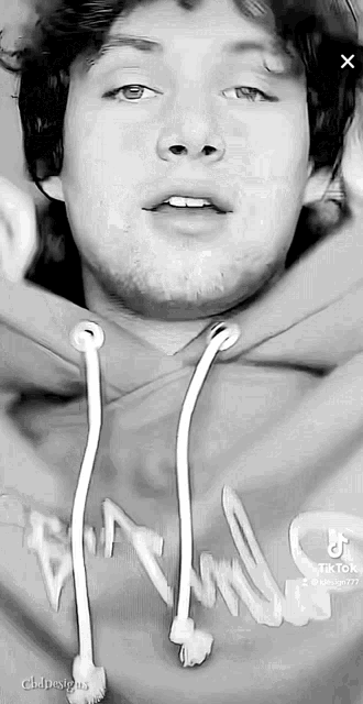 a black and white photo of a man in a hoodie
