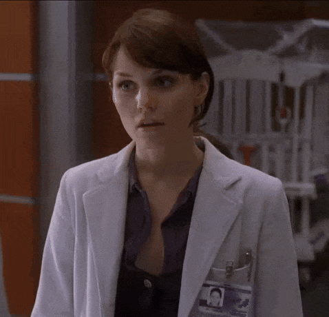 a woman in a white lab coat has a name tag on her chest that says ' elizabeth ' on it