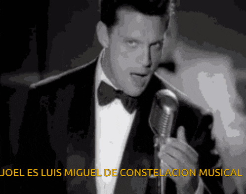 a man in a tuxedo singing into a microphone with the words joel es luis miguel de constellation musical
