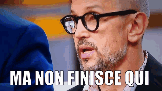 a man with glasses and the words ma non finisce qui