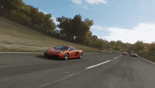 a red sports car is driving down a road in a video game