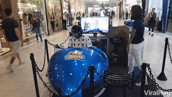 a man is playing a virtual reality game in a city coaster simulator