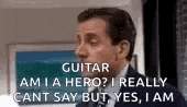 a man in a suit and tie is talking about a guitar and a hero .
