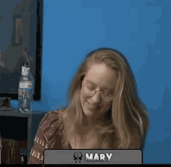 a woman giving a peace sign in front of a sign that says mary on it