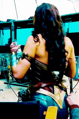 a woman in a wonder woman costume is sitting down