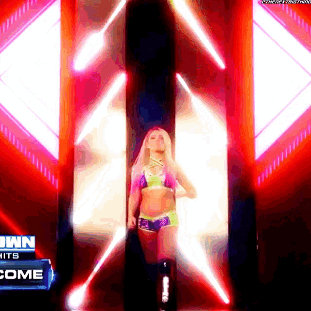 a woman in a bikini is walking through a tunnel with a sign that says ' n hits come '
