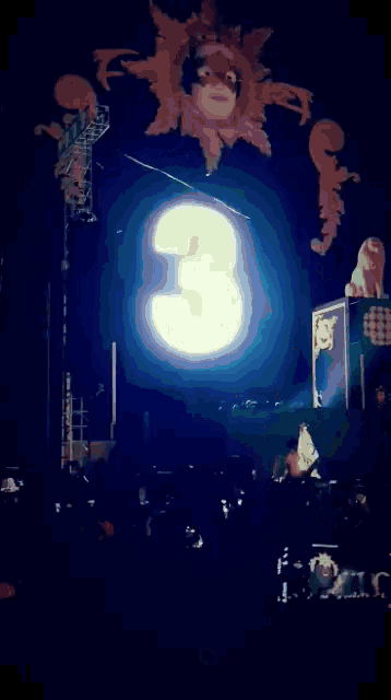 a sign that says happy new year is lit up at a concert