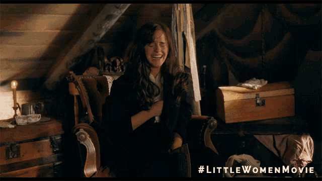 a woman is sitting in a chair with #littlewomenmovie written on it