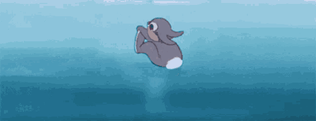 a cartoon rabbit is floating in the water .
