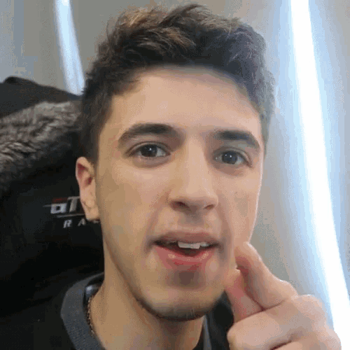 a close up of a young man 's face with a jacket that says ' u1 ' on it