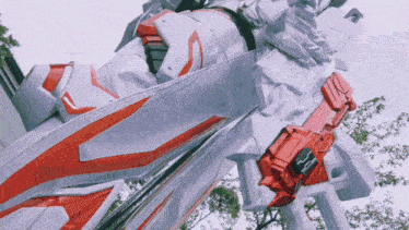 a statue of a robot with a red and white shield