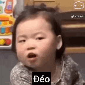 a baby girl is making a funny face with her mouth open and the word deo on her face .