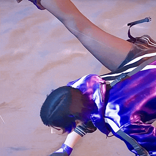 a person in a purple and black outfit is laying on the ground