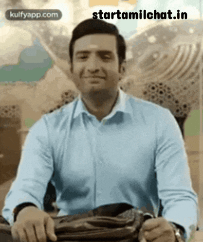 a man in a blue shirt is smiling while holding a purse .