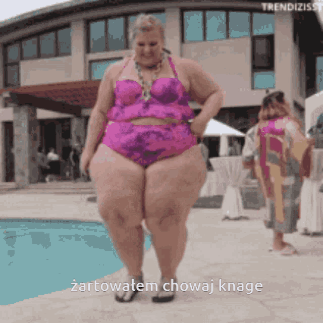 a woman in a pink bikini is standing next to a pool with the words " zartowatem chowaj knage " on the bottom