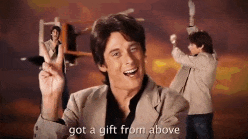 a man in a suit is giving a peace sign and saying `` got a gift from above ''