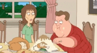 a man and a woman are sitting at a table with a turkey on it .