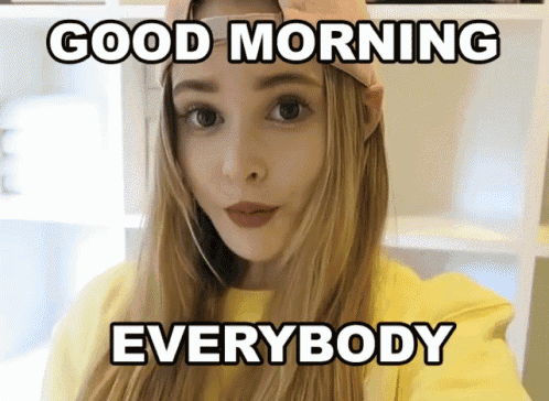 a woman wearing a hat and a yellow sweater says good morning everybody