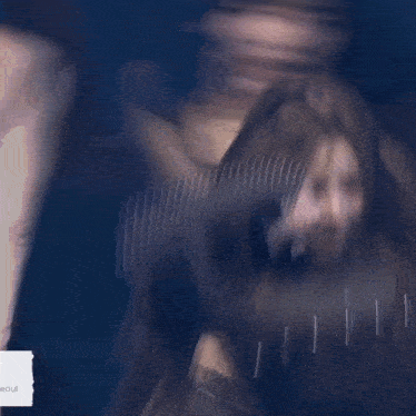 a woman with long hair is dancing on a stage with a microphone in her hand