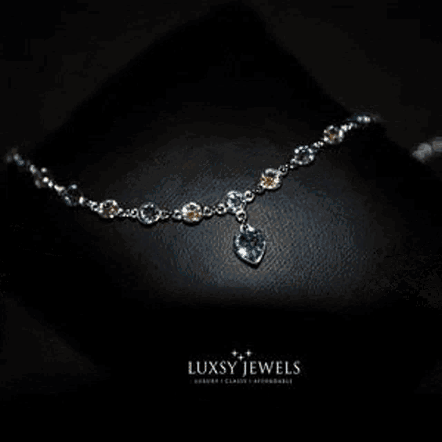a man wearing a gold chain bracelet with luxsy jewels written on the bottom