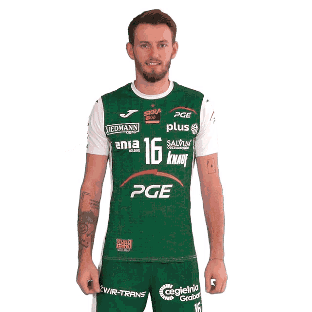 a man is wearing a green and white shirt with the number 16 on it
