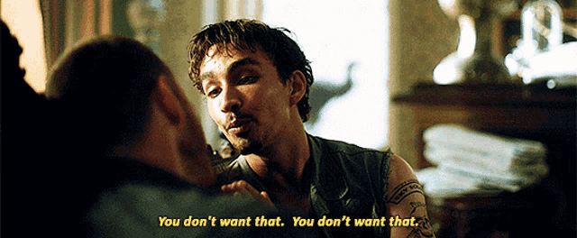 a man with a tattoo on his arm is talking to another man who says " you don t want that "