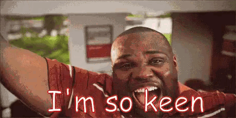a man in a red shirt is screaming with the words i 'm so keen below him .