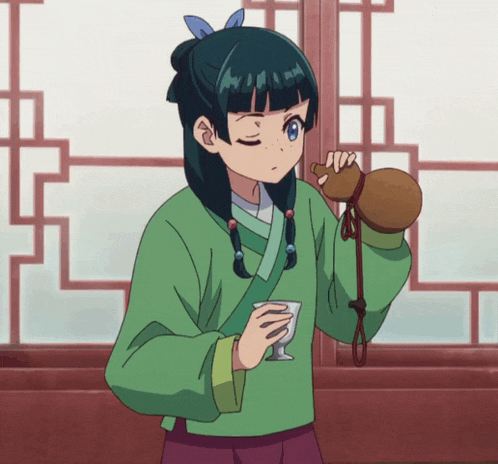 a girl in a green shirt is holding a brown bag