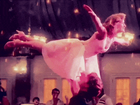 a woman in a pink dress is being lifted in the air