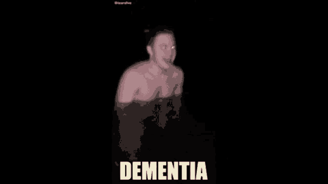 a person is standing in the dark with a light coming out of their head and the word dementia is on the bottom .