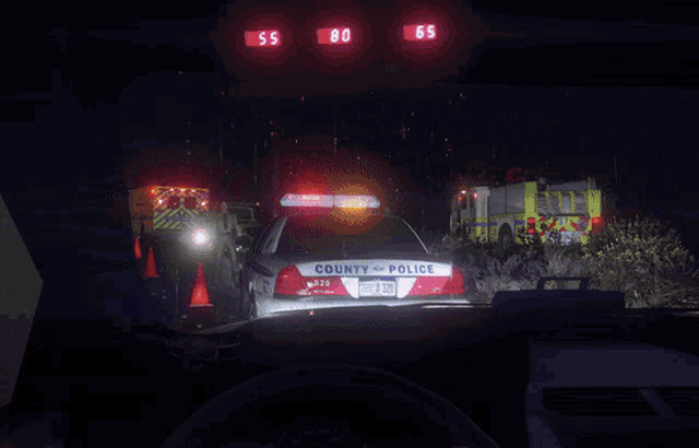 a county police car is parked in front of a fire truck