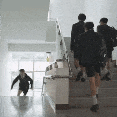 a group of people are walking up a set of stairs and one of them has a backpack that says ' abercrombie '