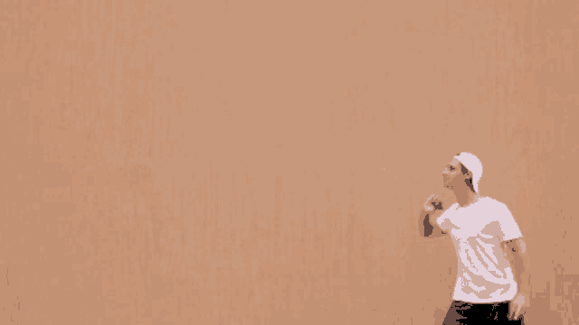 a man wearing a white hat is throwing a ball in the air