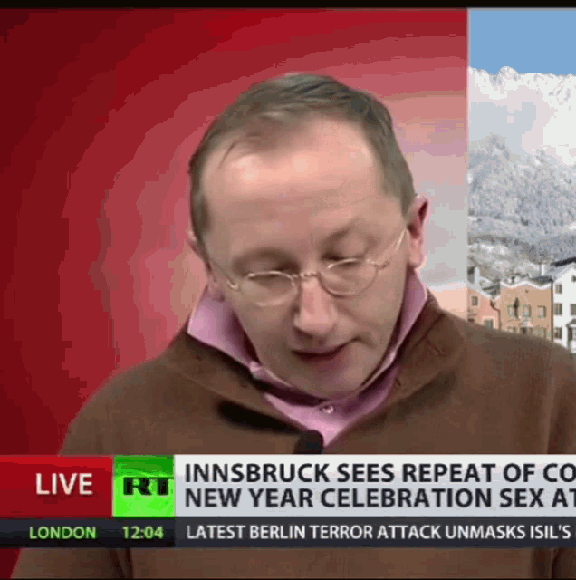 a man wearing glasses stands in front of a news report that says innsbruck sees repeat of co new year celebration sex
