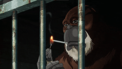 a monkey is smoking a cigarette through a cage