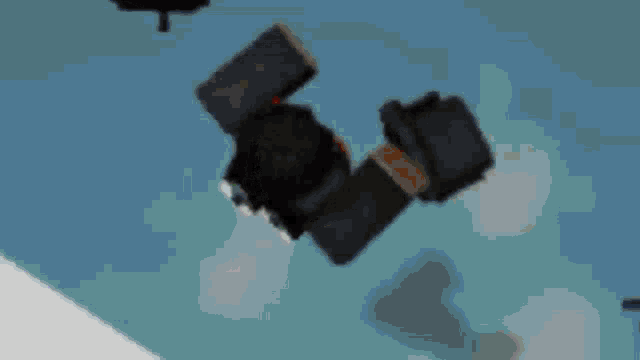 a black object is sitting on a blue surface