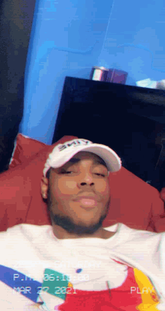 a man wearing a hat and a shirt with the date mar 29 2021 on it
