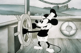 mickey mouse is driving a boat with a steering wheel .