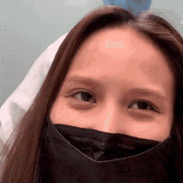 a close up of a woman wearing a mask