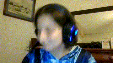 a girl wearing headphones is making a funny face in a blurry photo .
