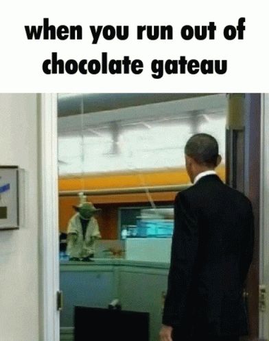 a man in a suit is walking out of a chocolate cake