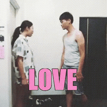 a man and a woman are standing next to each other with the word love in pink letters